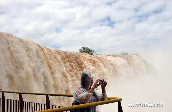 A woman visits the Iguazu Falls in Foz do Iguazu at the southern border of Brazil, Feb. 15, 2011. Due to recent heavy rains, the flow of the Iguazu Falls increased from 1,500 cubic meters per second to 6,500 cubic meters per second. 