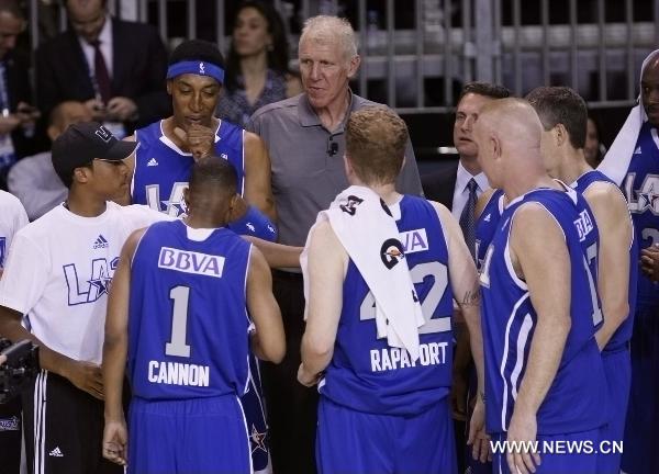 The coach of the East team, former NBA player Walton (C) speaks to his players during the 2011 BBVA All-Star Celebrity basketball game as a part of the NBA All-Star basketball weekend in Los Angeles, the United States, Feb. 18, 2011