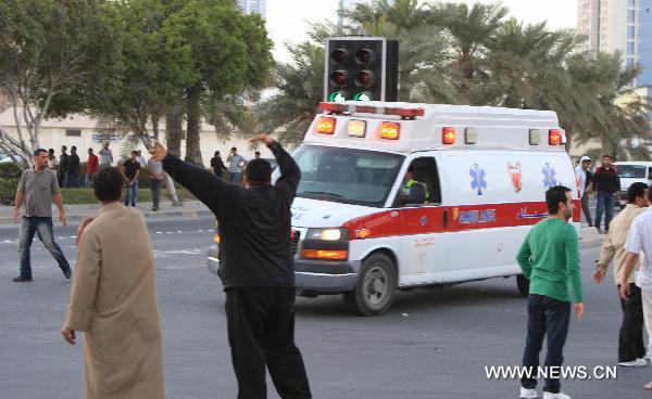 An ambulance carrying wounded protestors rushes to a hospital in Manama, capital of Bahrain, Feb. 18, 2011. Dozens of protestors were wounded in a clash between protestors and soldiers and police on Friday at Pearl Square in Manama. 