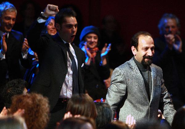 Iranian Director Asghar Farhadi walks towards the stage after winning the Golden Bear award for Best Film during the awards ceremony at the 61st Berlinale International Film Festival in Berlin, Feb. 19, 2011. [Xinhua]