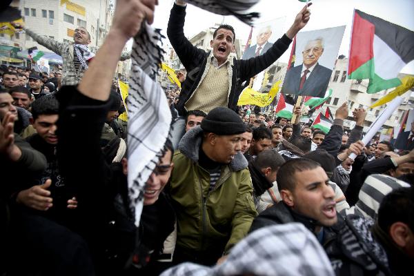 Palestinian Fatah supporters take part in a rally to support Palestinian President Mahmoud Abbas and to protest the U.S. veto, in the West Bank city of Ramallah, on Feb. 20, 2011. About 2000 Palestinians demonstrated Sunday against the U.S veto in the United Nations Security Council against a draft resolution condemning Jewish settlement in the occupied Palestinian territories. [Fadi Arouri/Xinhua]