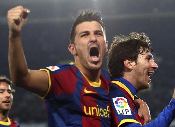 Barcelona's David Villa celebrates with Lionel Messi for his goal against Athletic Bilbao during their Spanish first division soccer match at Nou Camp stadium in Barcelona February 20, 2011. (Xinhua/Reuters Photo) 