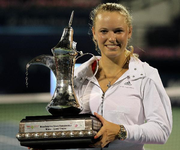 Caroline Wozniacki of Denmark holds her trophy after beating Svetlana Kuznetsova of Russia in their WTA Dubai Tennis Championship final match in the Gulf emirate. (Xinhua/AFP Photo) 