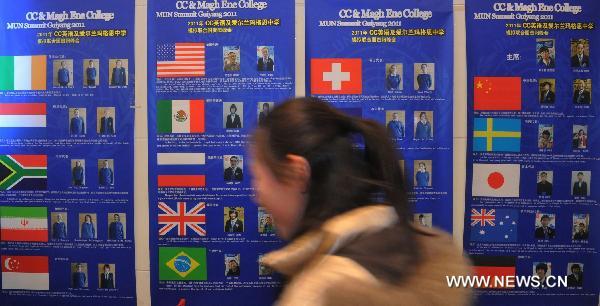 A student walks by posters of a simulative activity of Model United Nations in Guiyang, capital of southwest China's Guizhou Province, Feb. 20, 2011. A Guizhou-Ireland Youth Culture Week was held from Feb. 16 to Feb. 23, during which twenty-two Irish youngsters experienced the ordinary Chinese daily life and culture, as well as attended exchange activities with Chinese students.