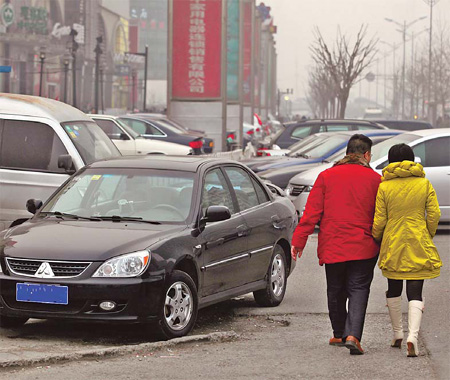 A pavement in Wangjing is blocked by illegally parked cars, a common sight in Beijing. 