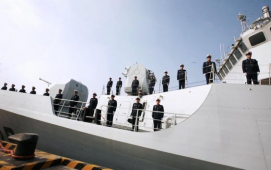China's navy officers sent out to the Gulf of Aden for the eighth anti-piracy mission wave goodbye aboard a missile destroyer in Zhoushan, East China's Zhejiang province, Feb 21, 2011. [Xinhua]