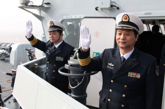 China's navy officers sent out to the Gulf of Aden for the eighth anti-piracy mission wave goodbye aboard a missile destroyer in Zhoushan, East China's Zhejiang province, Feb 21, 2011. [Xinhua]