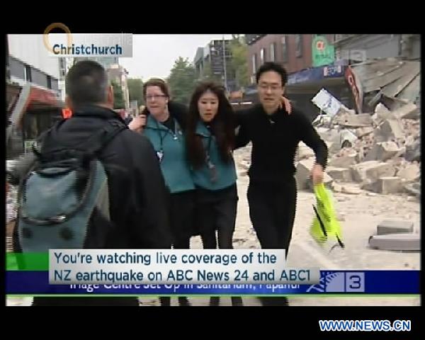 TV grab taken on Feb. 22, 2011 shows people evacuating from a quake-damaged street in Christchurch, New Zealand. A massive 6.3 earthquake hit New Zealand South Island's largest city of Christchurch for the second time in less than six months, causing multiple deaths and widespread destruction. [Xinhua]