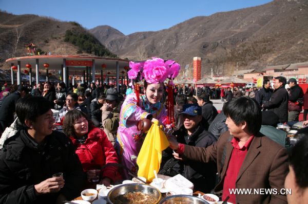 Local residents gather to celebrate the traditional Lianqiao Festival in Yangshudixia Village of Beijing, capital of China, Feb. 18, 2011.