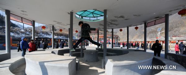 A boy plays at a fete dining place where people celebrate the traditional Lianqiao Festival in Yangshudixia Village of Beijing, capital of China, Feb. 17, 2011.