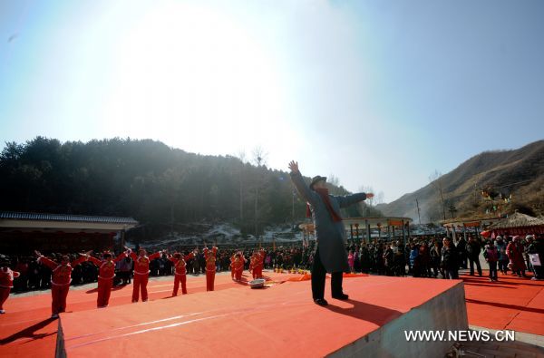 A man pays tributes during the traditional Lianqiao Festival in Yangshudixia Village of Beijing, capital of China, Feb. 17, 2011.