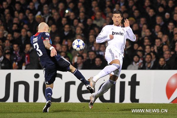 Real Madrid's Cristiano Ronaldo(R) fights for the ball with Cris of Olympique de Lyon during their UEFA Champions League football match at the Gerland stadium in Lyon, central eastern France, Feb. 22, 2011. The match tied with a 1-1 draw. (Xinhua/Laurent Zablon) 