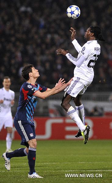 Real Madrid's Emmanuel Adebayor(R) heads the ball during the UEFA Champions League football match against Olympique de Lyon at the Gerland stadium in Lyon, central eastern France, Feb. 22, 2011. The match tied with a 1-1 draw. (Xinhua/Laurent Zablon) 