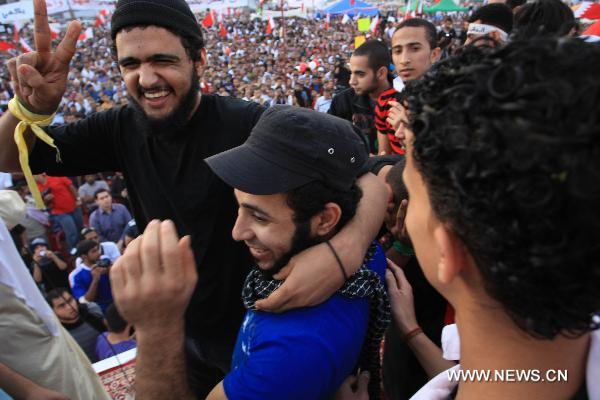 Newly released prisoners join the anti-government protest at the Pearl Square in Manama, Bahrain, Feb. 23, 2011. The Bahraini government on Wednesday announced the release of 308 prisoners following the orders by the leadership. Among those released are 23 terrorist suspects, who were charged to be a part of a cell aimed to jeopardize state security. The Information Affairs Authority said the decision to release the men was made by King Hamad bin Isa Al Khalifa. [Xinhua]