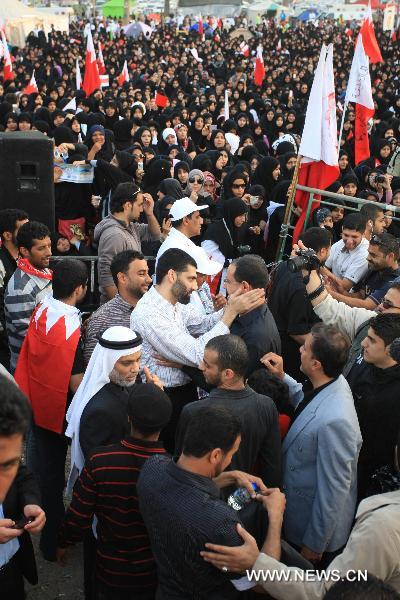 Newly released prisoners join the anti-government protest at the Pearl Square in Manama, Bahrain, Feb. 23, 2011. The Bahraini government on Wednesday announced the release of 308 prisoners following the orders by the leadership. Among those released are 23 terrorist suspects, who were charged to be a part of a cell aimed to jeopardize state security. The Information Affairs Authority said the decision to release the men was made by King Hamad bin Isa Al Khalifa. [Xinhua]