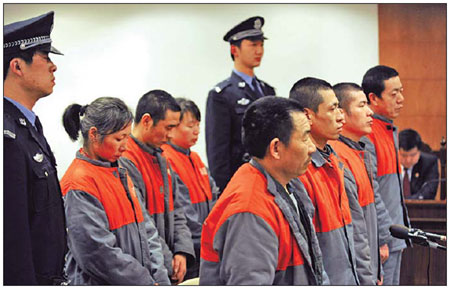 Seven child traffickers stand at Haidian district court on Wednesday. They each face sentences of five to 10 years.
