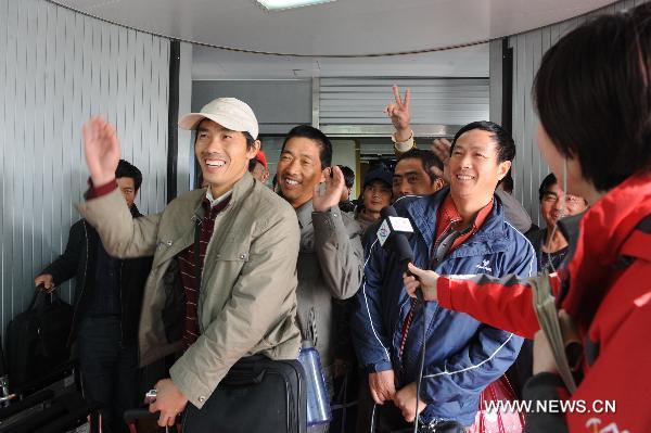 Chinese workers arrive at the Beijing Capital International Airport in Beijing, capital of China, Feb. 24, 2011. The first group of 43 Chinese evacuated from riot-torn Libya arrived in Beijing Thursday morning on a flight from Egypt's northern city of Alexandria. [Ma Ruzhuang/Xinhua]