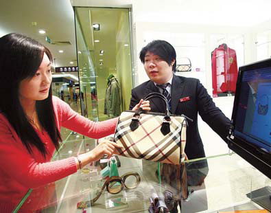 A customer shops at a counter providing overseas purchasing services in Beijing Modern Plaza in this file photo taken in 2009. Provided to China Daily
