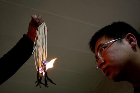 A man stares at burning noodles in Xi'an, Shaanxi Province. Photo: CFP