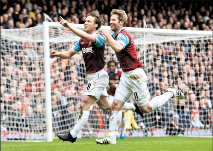 West Ham United's Scott Parker (left) celebrates his goal against Liverpool with teammate Thomas Hitzlsperger during their English Premier League match at Upton Park, London, yesterday. The Hammers won 3-1.  