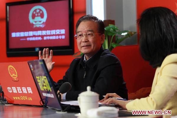 Chinese Premier Wen Jiabao (L) holds an online chat with Internet users at two state news portals in Beijing, capital of China, Feb. 27, 2011. The two portals, namely www.gov.cn of the central government and www.xinhuanet.com of the Xinhua News Agency, jointly interviewed Premier Wen on Sunday with questions raised by netizens. [Pang Xinglei/Xinhua] 