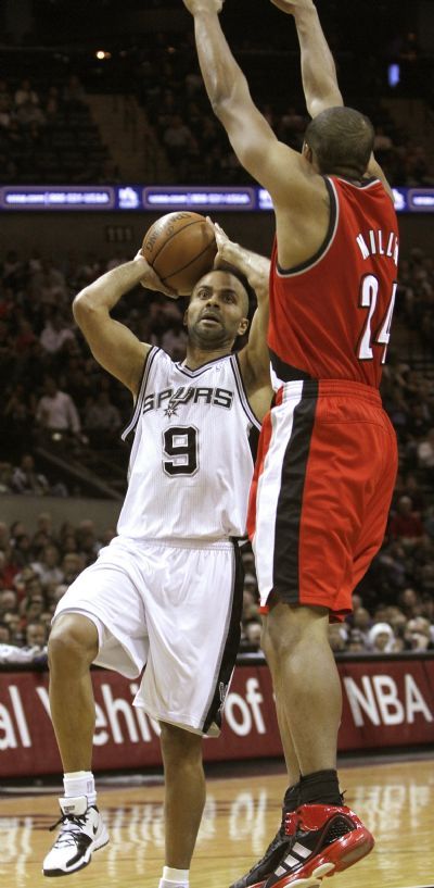 San Antonio Spurs Parker goes to the basket against Portland Trail Blazers' Miller during the first half of their NBA basketball game in San Antonio REFILE - CORRECTING TEAM NAME  San Antonio Spurs Tony Parker (L) goes to the basket against Portland Trail Blazers' Andre Miller during the first half of their NBA basketball game in San Antonio, Texas, December 12, 2010.  (Xinhua/Reuters)