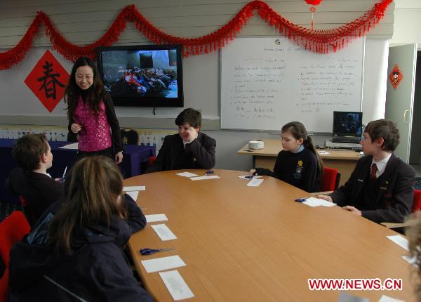 A Chinese teacher interacts with students during the opening of the Confucius Classroom at the Llandovery College in Wales, Britain, March 1, 2011. 