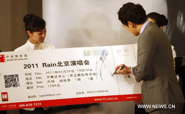 South Korean singer and actor Rain signs on a promotion board symbolizing the first ticket for his concert at a press conference in Beijing, capital of China, March 1, 2011. &apos;The Best&apos; 2011 Rain Aisa Tour will be held in Beijing on March 26, 2011.