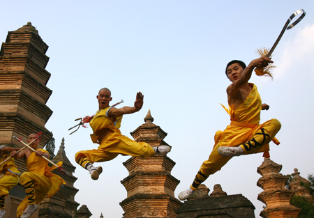 Two monks perform Chinese kungfu at the Shaolin Temple in Dengfeng, Henan Province, for visitors. The Shaolin Temple will promote Buddhism more aggressively this year. 