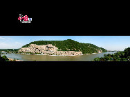 The Longmen Grottoes, located near Luoyang, Henan Province, are a treasure house of ancient Buddhist cave art. The grottos were hewed and carved during the Northern Wei Dynasty (386-534), when the rulers relocated their capital at Luoyang near the end of the 5th century. The construction of the Longmen Grottoes began in 493 during the reign of Emperor Xiaowen and continued through the successive six dynasties, including Tang and Song, for a span of over 400 years.  [Courtesy of Longmen Grottoes Scenic Spot]