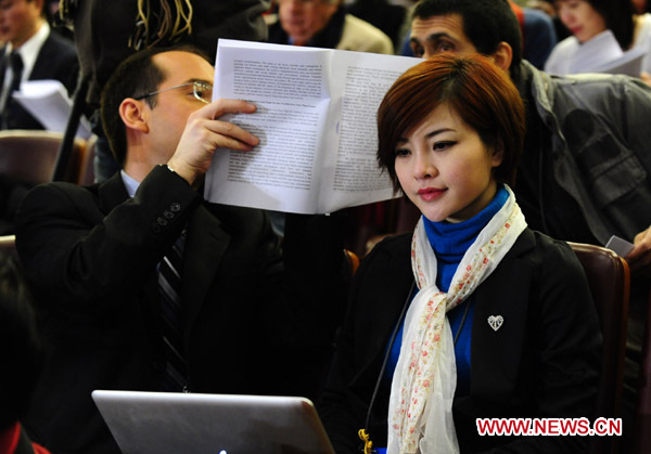 Journalists work during the opening meeting of the Fourth Session of the 11th National People's Congress (NPC) at the Great Hall of the People in Beijing, capital of China, March 5, 2011. [Ren Yong/Xinhua] 
