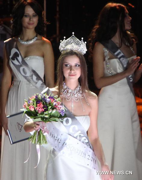 Crowned Natalia Gantimurova poses for photos during the final of Miss Russia pageant in Moscow, Russia, March 5, 2011. Natalia Gantimurova from Moscow was titled the Miss Russia 2011 on Saturday.