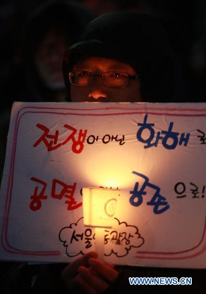 A South Korean man holds candle during a protest against the South Korea-U.S. military drills in Seoul, March 5, 2011.