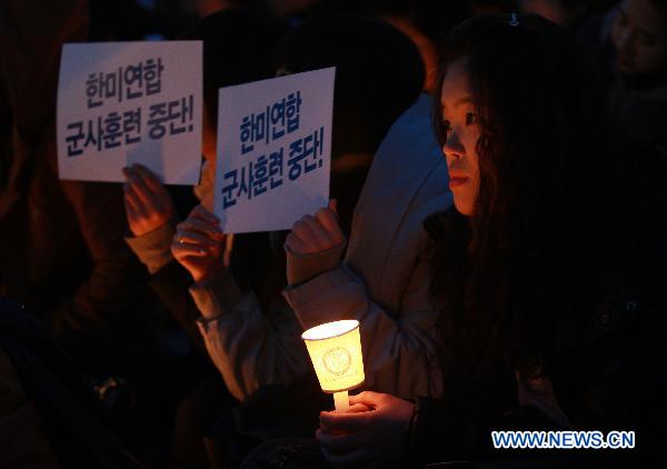 South Koreans shout slogans during a protest against the South Korea-U.S. military drills in Seoul, March 5, 2011. 