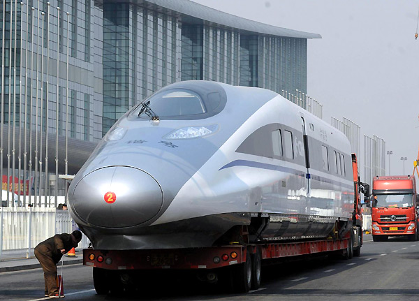 A worker at the China National Convention Center prepare to transport a locomotive of the domestically developed &apos;Harmony&apos; bullet train to the Center&apos;s square for a technological achievement exhibition in Beijing, March 5, 2011. 