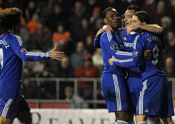 Chelsea's John Terry (2nd R) celebrates with teammates after scoring during their English Premier League soccer match against Blackpool, in Blackpool, northern England March 7, 2011. Two goals from Frank Lampard and another from John Terry gave Chelsea a 3-1 win at Blackpool on Monday to renew its hopes of retaining the Premier League title.(Xinhua/Reuters Photo) 