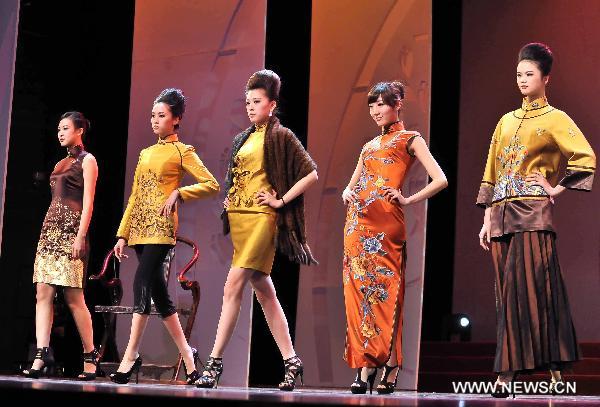 Women presents Cheongsam during an activity marking the International Women's Day in east China's Shanghai Municipality, March 7, 2011. Women from different sectors of the society in Shanghai, including female artists, entrepreneurs and diplomatic personnel participated in the Cheongsam Show. 