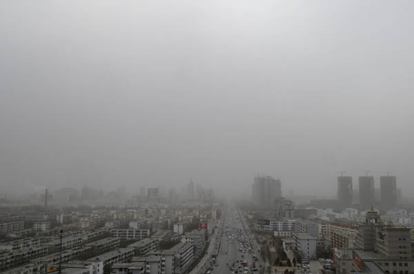 A view of buildings shrouded in dust and sand amid a sandstorm in Yinchuan, capital of Northwest China&apos;s Ningxia Hui autonomous region, March 8, 2011. 