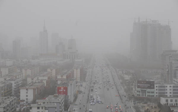 A view of buildings shrouded in dust and sand amid a sandstorm in Yinchuan, capital of Northwest China&apos;s Ningxia Hui autonomous region, March 8, 2011.