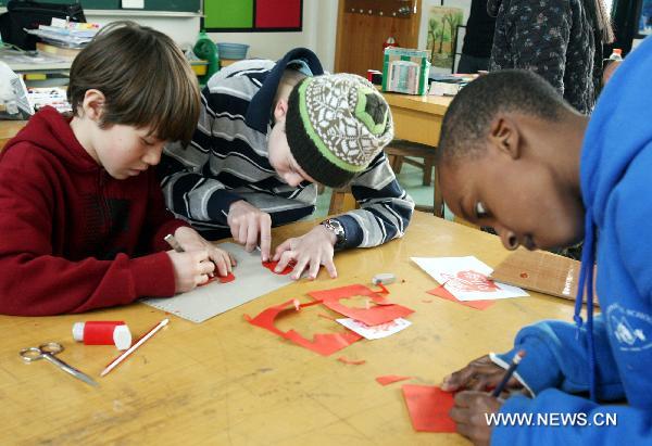 Students from the U.S. have have discussions at Blue Tassel School in Suzhou, east China's Jiangsu Province, March 9, 2011. A total of 15 students from a school in Portland, the U.S., arrived in Suzhou to spend one week learning Chinese language, pottery arts, paper cuttings, etc.