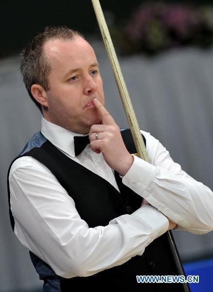 World No.1 player John Higgins of Scotland reacts during the group round against Peter Ebdon of England at the Hainan Snooker Classic in Boao, South China's Hainan Province, March 10, 2011. Higgins won the match 2-1.(Xinhua/Guo Cheng) 