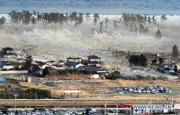 A massive tsunami engulfs a residential area after a powerful earthquake in Natori, Miyagi Prefecture, northeastern Japan, on March 11, 2011. An earthquake measuring 8.8 on the Richter scale jolted off the east coast of Japan's main Honshu island Friday.