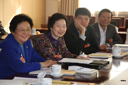 Deputies to National People's Congress (NPC) react during NPC deputies' panel discussion on work report of NPC Standing Committee in Beijing, on Friday, March 11, 2011. 