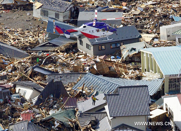 A victim is rescued by helicopter following an earthquake and tsunami in Iwate Prefecture, northeastern Japan March 12, 2011. Japan confronted devastation along its northeastern coast on Saturday, with fires raging and parts of some cities under water after a massive earthquake and tsunami that likely killed at least 1,000 people