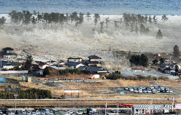 A massive tsunami engulfs a residential area after a powerful earthquake in Natori, Miyagi Prefecture, northeastern Japan, on March 11, 2011. An earthquake measuring 8.8 on the Richter scale jolted off the east coast of Japan's main Honshu island Friday. 