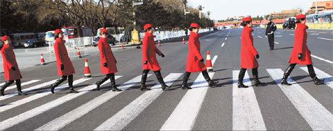 Women in red: Female ushers in scarlet coats draw many eyeballs.