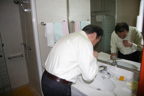 Chu Junhao, deputy to the National People's Congress (NPC), China's top legislature, washes off the mirror in the morning at Jingxi hotel in Beijing on Friday, March 11, 2011. Usually Chu gets up before 7am at Jingxi hotel to begin his new day during the fourth session of the 11th NPC, which opened in Beijing March 5 and will conclude March 14. 