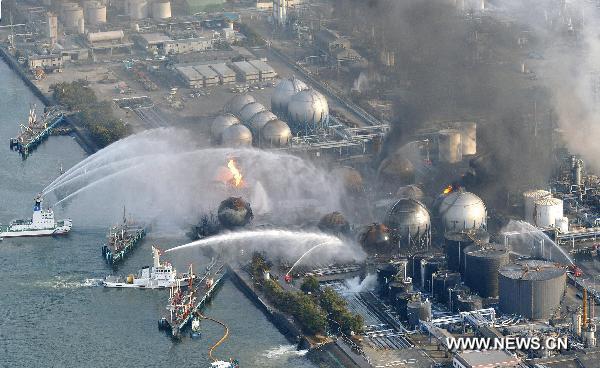 The fire fighting is still in process at the Cosmo oil refinery in the city of Ichihara March 12, 2011.Over 1,000 people has been killed after Friday's great earthquake and ensuing huge tsunami hit northeast Japan, public broadcaster NHK reported Saturday. [Xinhua]