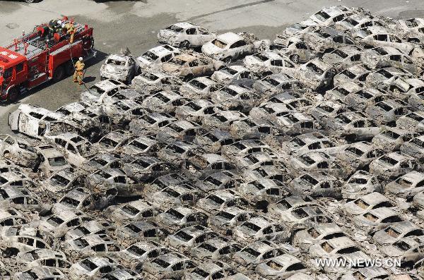 Photo shows burnt vehicles that have been swept together at the port of Hitachi in Ibaraki Prefecture on March 12, 2011. Over 1,000 people has been killed after Friday's great earthquake and ensuing huge tsunami hit northeast Japan, public broadcaster NHK reported Saturday. [Xinhua]