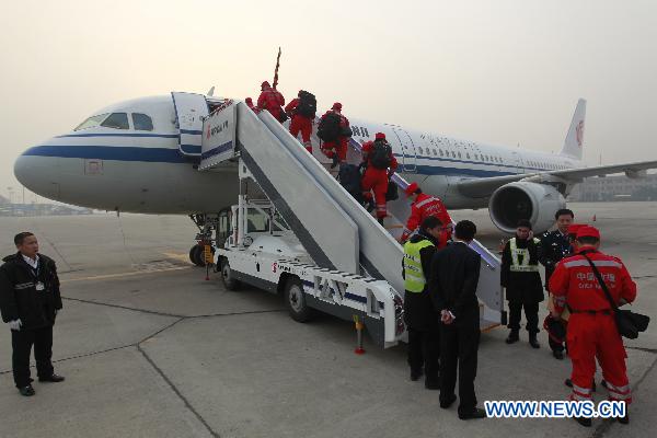 Members of the China's International Rescue Team board the plane at Beijing Capital International Airport in Beijing, capital of China, March 13, 2011. The China's International Rescue Team including 15 members left for the quake-hit region in Japan Sunday morning. [Xinhua]